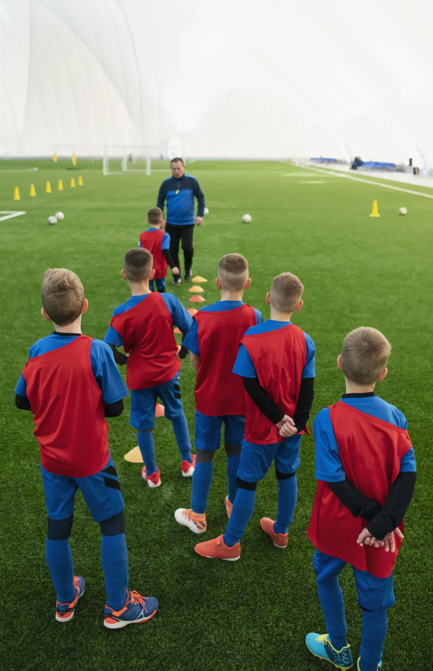 Kids training together on the soccer field at HappyFeet