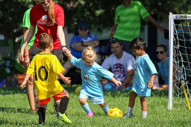 Kids playing a soccer scrimmage near the goal at HappyFeet